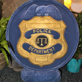 Blue and gold police department plaque with an eagle emblem