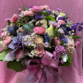Mixed pink and purple bouquet in a gift box with a satin ribbon