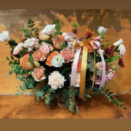 Peach and white mixed flower arrangement with ribbon in a vase