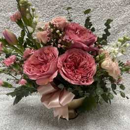 Pink rose bouquet in a gold vase with a satin ribbon