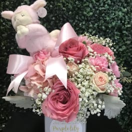 Pink rose bouquet with a plush lamb and satin ribbon in a box