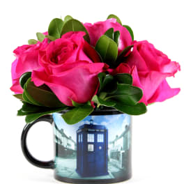 Pink roses arranged in a mug with a blue police box design