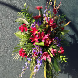 Bright tropical floral spray with pink lilies and purple accents