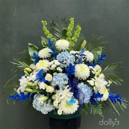Large blue and white floral arrangement with hydrangeas and chrysanthemums