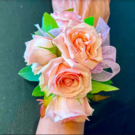 Pink rose wrist corsage with a lavender ribbon