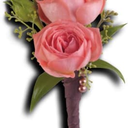 Pink rose boutonniere with green buds and leaves