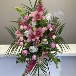 Pink lily and rose standing arrangement with palm fronds