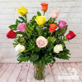 Mixed-color roses arranged in a clear glass vase