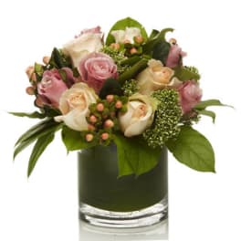 Pink and cream rose bouquet in a clear glass vase