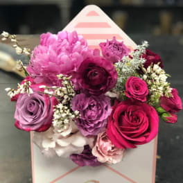 Pink and purple rose bouquet in a white gift box