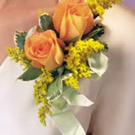 Small orange rose boutonniere with yellow filler flowers and ribbon