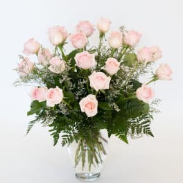 Bouquet of pale pink roses in a clear glass vase
