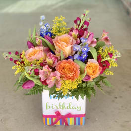 Mixed bouquet in a birthday gift box with roses and colorful blooms