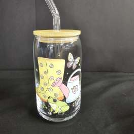 Clear glass tumbler with a bamboo lid and straw, decorated with a frog and butterfly graphic