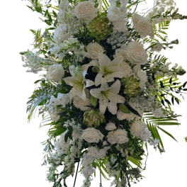Large white floral standing spray on an easel
