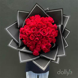 Large bouquet of red roses wrapped in black paper