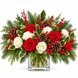 Holiday bouquet of red and white roses in a clear glass vase
