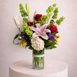 Mixed bouquet with lilies, roses, and hydrangea in a glass vase