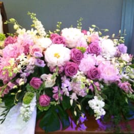 Large pink and white floral arrangement with roses and peonies