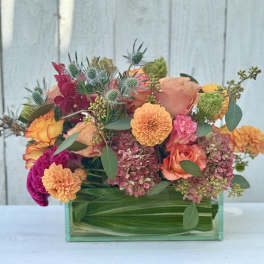Colorful mixed bouquet in a rectangular glass vase