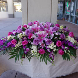 Large pink and purple floral arrangement on a table