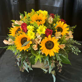 Sunflower and red rose arrangement in a wooden box