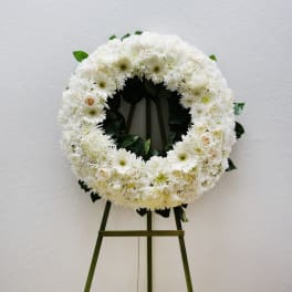 White floral wreath on a standing easel