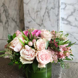 Pink and white roses arranged in a green vase