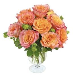 Bouquet of peach and pink roses in a clear glass vase