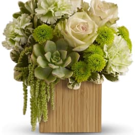 White roses and green flowers arranged with a succulent in a wooden box