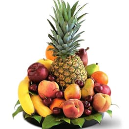 Fruit arrangement with pineapple, bananas, pears, peaches, grapes, and apples