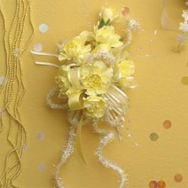Yellow floral corsage with ribbon and glittery accents