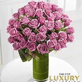 Pink roses arranged in a tall green vase