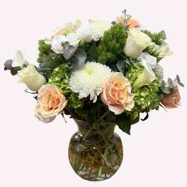 Bouquet of peach and white flowers in a glass vase