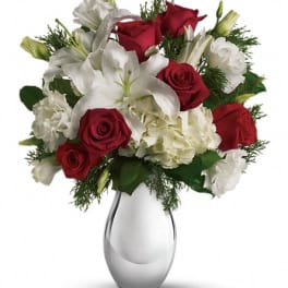 Red roses and white lilies in a silver vase