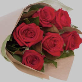 Bouquet of red roses wrapped in tan paper