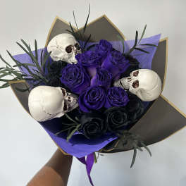 Purple and black rose bouquet with skull decorations