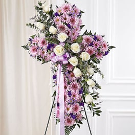 Standing floral spray of pink and white flowers with a lavender ribbon