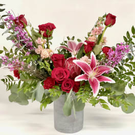 Red roses and pink lilies in a gray vase