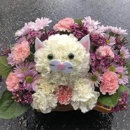 Cat-shaped flower arrangement with pink and white blooms