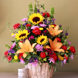 Basket arrangement with sunflowers, lilies, and mixed blooms