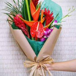Tropical bouquet with red ginger, orange heliconia, and purple orchids