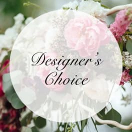 Pink and white floral arrangement with a "Designer’s Choice" label
