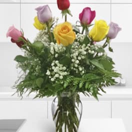 Bouquet of multicolored roses in a clear glass vase