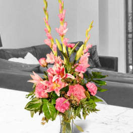 Pink floral arrangement in a clear glass vase