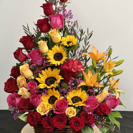 Large basket arrangement of roses, sunflowers, and lilies