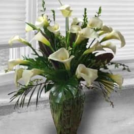 White calla lily arrangement in a glass vase