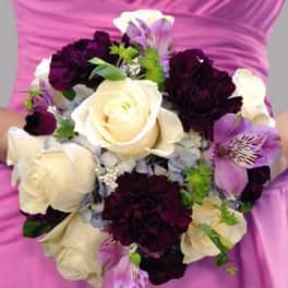 Bouquet of white roses, dark purple carnations, and lavender lilies