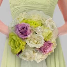 Bridal bouquet of pastel roses with decorative accents