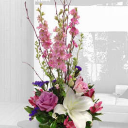 Tall bouquet with pink and white flowers in a low container
